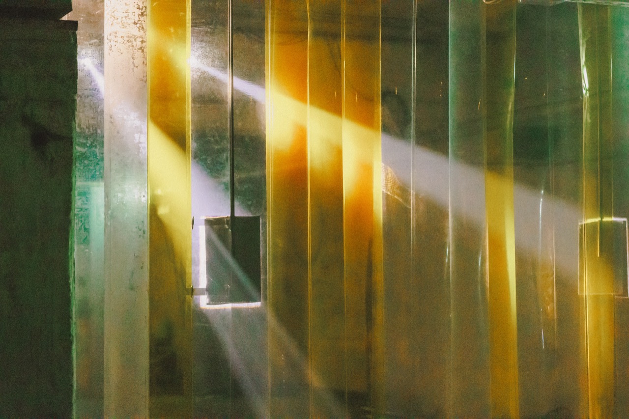 Sunlight through amber and green glass panels