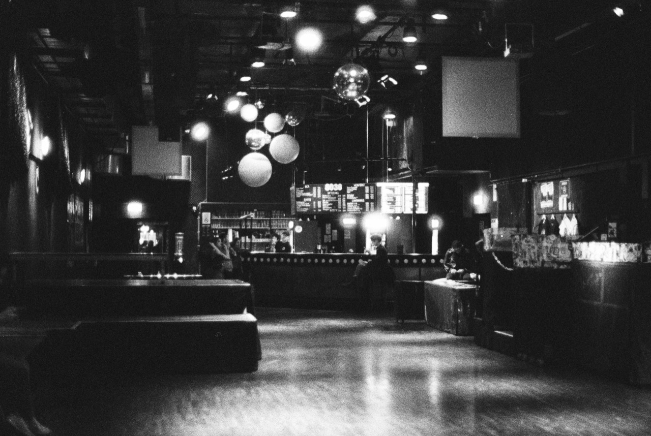An empty club with a disco ball, in black and white